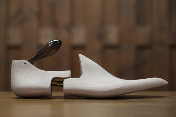 Bondeno bespoke shoe trees in pale beechwood with a dark wooden club handle, side view